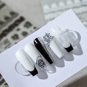 Elegant black and white press-on nails with vintage rose patterns and lace details
