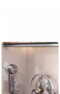 Detail of suction cup pot lid rack mounted on tiles showing secure no-drill installation