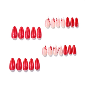 Almond-shaped press-on nails with sweet red floral designs and glossy red finish