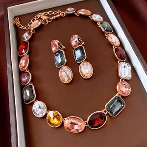 Vintage gold jewelry set with colorful geometric crystals in a luxury gift box