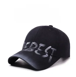 Detail view of black washed baseball cap featuring white distressed graffiti print