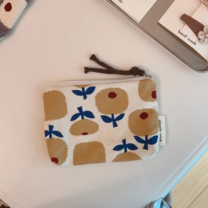 Detailed shot of floral canvas mini pouch with yellow flowers and simple wish tag