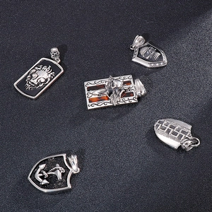 Detailed view of vintage anchor shield pendants with skull and rhinestone accents