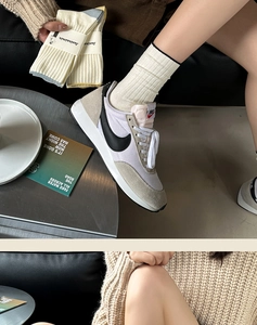 Close-up of comfortable white ribbed cotton socks paired with retro gray sneakers