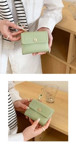 Close-up of green tri-fold women's wallet with gold snap button and wrist strap detail