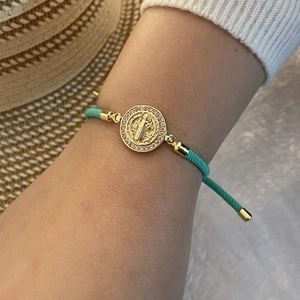 Detail of 18K gold-plated Virgin Mary woven bracelet with micro-set cubic zirconia