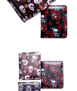 Detail view of gothic bifold wallets with skull, rose, and spider web printed patterns