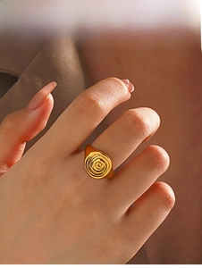 Detailed view of an 18K gold plated spiral ring featuring a modern swirl geometric design