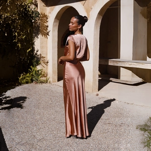 Close-up of rose gold satin evening dress showing smooth texture and backless detail