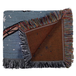 Detailed close-up of bohemian woven throw blanket showing double-sided texture and colorful fringe