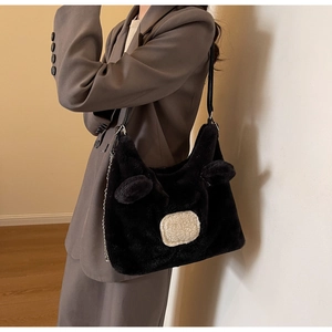 Detail view of black faux fur shoulder bag featuring cute bear ears and silver chain strap