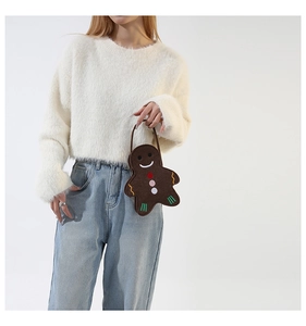 Detailed view of ginger man felt handbag styled with a cozy cream sweater and denim
