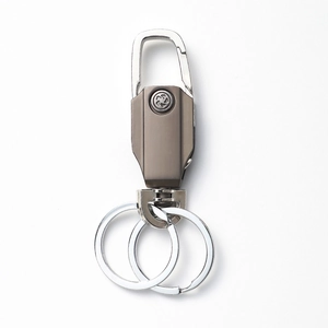 Macro shot of gun-black metal keychain with silver carabiner and dual keyring detail
