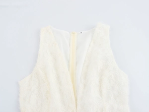 Detail view of deep V-neckline and back hidden zipper on beige floral lace dress