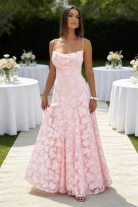 Macro view of floral lace texture and delicate straps on pink evening dress