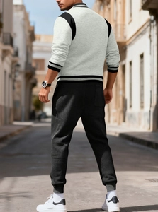 Back view of a casual two-piece tracksuit with contrast sleeve paneling and elastic cuffs