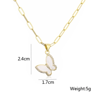 Detail view of gold butterfly pendant showing dimensions 2.4x1.7cm and weight 5g