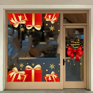 Window display view of red bow and snowflake Christmas stickers with Happy New Year text