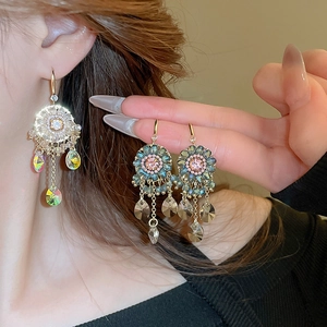 Close-up of Bohemian colorful crystal floral earrings with deep blue tassel droplets