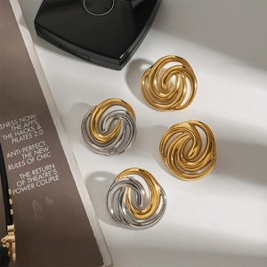 Macro shot of 18k gold plated stainless steel spiral earrings with metallic luster