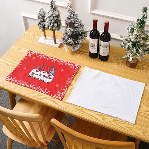Detailed view of Christmas forest gnome placemats on a festive wooden table setting