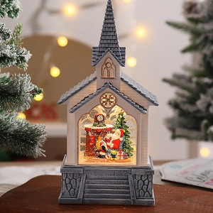 Close-up of lighted Santa house water globe with glitter snow and holiday interior