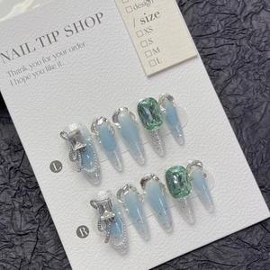 French blue gradient press-on nails with luxury emerald gemstone and silver bow charms