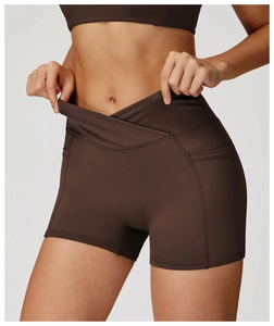 Close-up of high waist yoga shorts featuring a cross V-waistband and functional side pocket