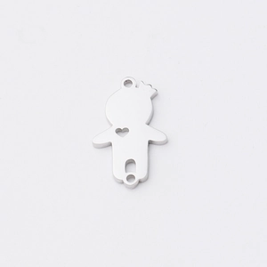 Close-up of a silver stainless steel boy girl charm with heart cutout for DIY jewelry
