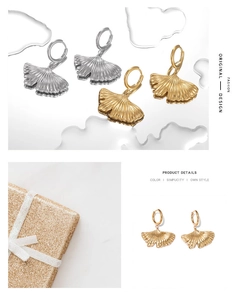 Detail view of stylish ginkgo leaf earrings in gold and silver finish with gift packaging