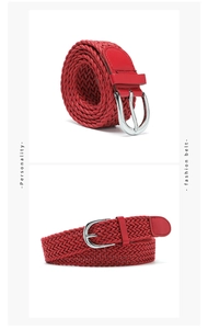 Detail of red braided elastic belt with silver D-ring buckle and textured weave