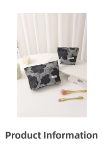 Close-up of vintage floral embroidery on dark blue jacquard fabric cosmetic bag