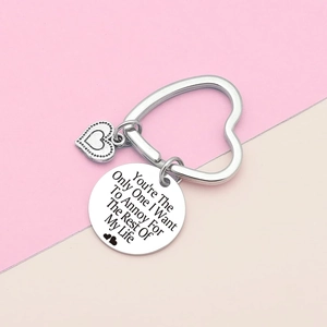 Macro shot of silver stainless steel heart keychain with personalized engraved pendant