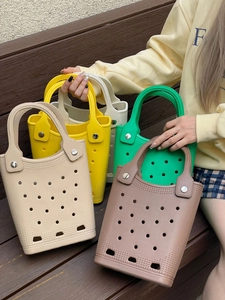 Waterproof EVA beach bags in multiple colors shown on a wooden bench outdoors