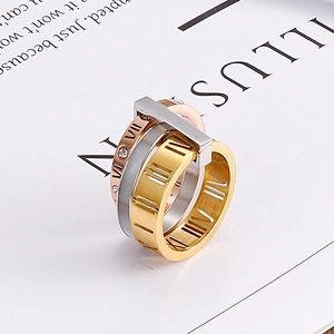 Close-up of three-tone stainless steel interlinked rings with Roman numerals and zircon