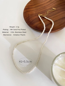 Detailed view of 18K gold PVD plated clasp and imitation pearls on 316L stainless steel chain