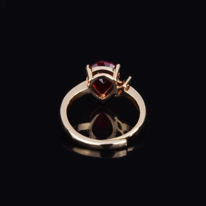 Adjustable 18k gold plated ring with pear-cut ruby red stone and green accent gems