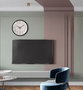 Detail of 12-inch black minimalist wall clock on art wall in a modern living room