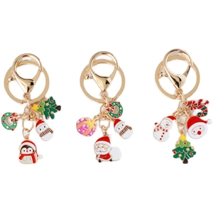 Three Christmas keychains with enamel Santa Claus, Snowman and Penguin pendants