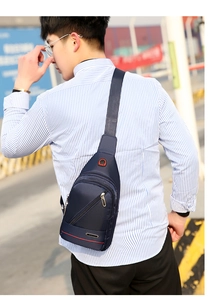 Close-up of waterproof dark blue oxford chest bag with multiple zippers and sport logo