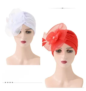 Detail of elegant mesh flower turban with white pearls on a vintage headwrap
