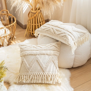 Bohemian cream throw pillow covers with tufted geometric patterns and fringe edges