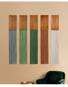 Detail showing five colored macrame wall hangings with wood panels and fiber tassels