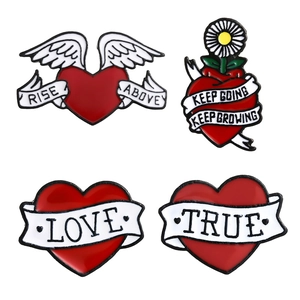 Set of four red enamel heart pins with motivational quotes and artistic wing designs