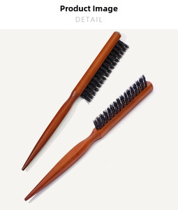 Macro view of three-row boar bristles and professional wooden pointed tail hair comb