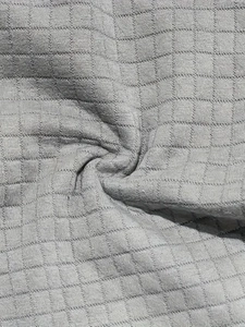 Macro shot of light gray waffle knit fabric texture on the summer leisure set