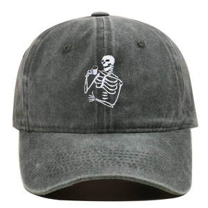 Gros plan détaillé de la broderie crâne buvant du thé sur casquette gris foncé délavé
