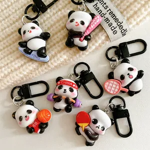 Set of cute sports panda keychains in various athletic poses on a cozy knit background