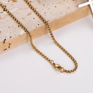 Sleek gold box chain necklace with lobster clasp on white background with stone decor