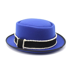 Detail of royal blue wool pork pie hat with pearl beaded black ribbon trim band